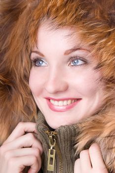 Young smiling woman in a jacket with a fur collar