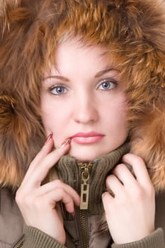 Young woman in a jacket with a fur collar