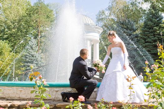 The groom gives flowers to the bride.