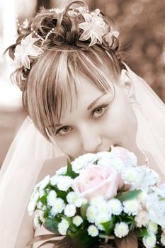 bride with a flower bouquet in sepia, but flowers in color