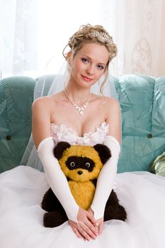 blond smiling bride with her favourite toy