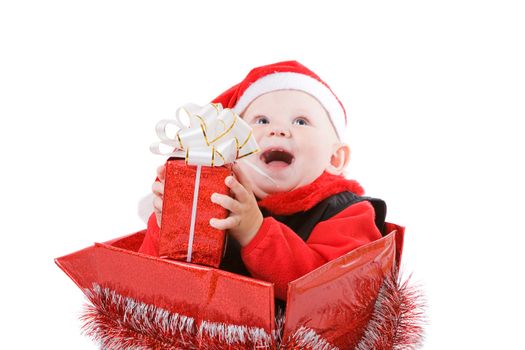 happy infant with gifts in the decorated christmas box
