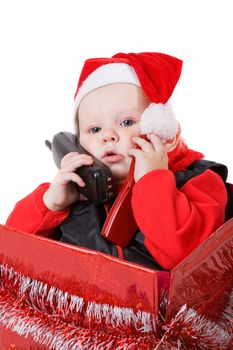 infant calling by phone in the decorated christmas box