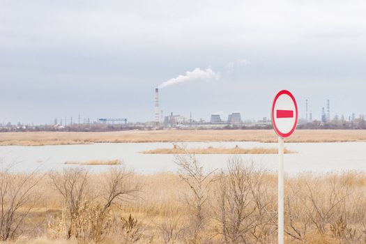 pollution of the environment as a smoke of a chimney of a factory and the sign forbidden