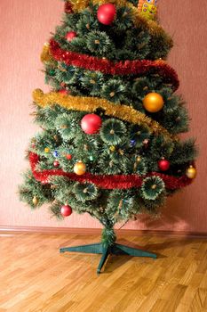 decorated christmas fir tree on the floor