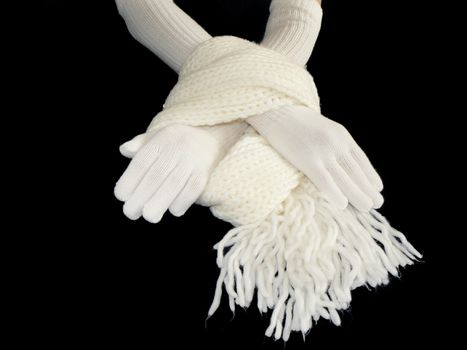 Hands in gloves and scarf on black background