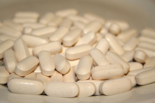 Close up of pills on a white background.
