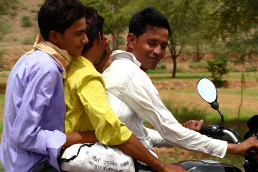 three men on one motorcycle