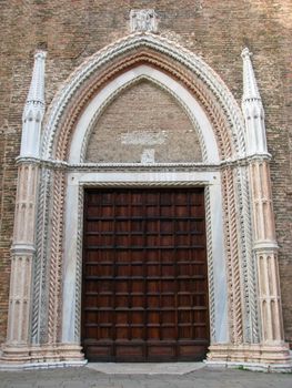 Ancient church door and ornate carvings at Frari Church in Venice, Italy.
