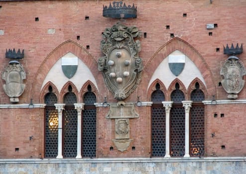 A medieval, renaissance Medici coat of arms in Siena, Italy Piazza Campo.
