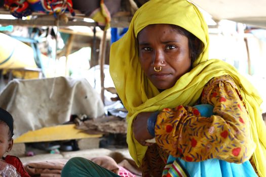 female wearing traditional yellow sari, India