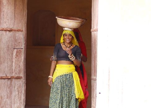 Asian lady wearing gray and yellow sari