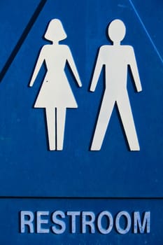 Close up of a unisex restroom sign.

