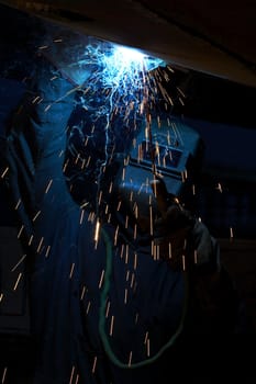 a welder working at shipyard at night