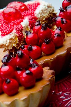 Cupcake with cherries and cheesecake with shallow depth of field