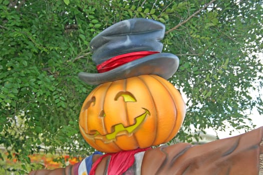 A pumpkin with smiling face and hat