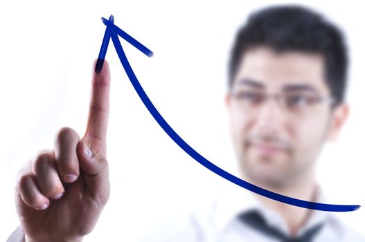 Young business man drawing a rising arrow on a glass board