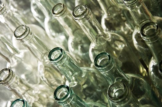 Close up of clear galss wine bottles waiting to be filled