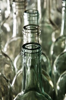 Closeup of empty clean & clear wine bottles lined up wating to be filled at a winery