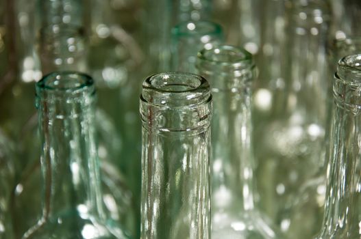 Close up of clear galss wine bottles waiting to be filled