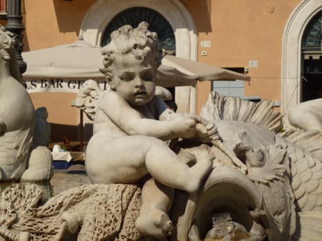 a statue of a boy on a fountain