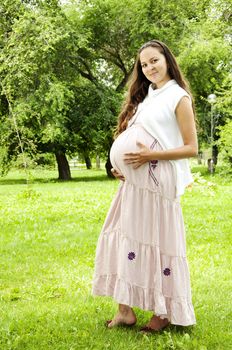 Pregnant Young Woman smile in summer park