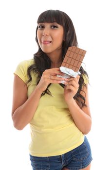 A pretty young beautiful woman holding a chocolate block and licking lips yum.  White background.