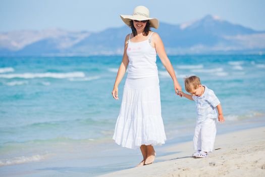 Young mother with her son on tropical beach vacation