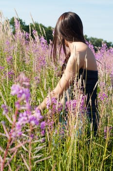 Outdoor shot of beautiful brunette woman with long hair