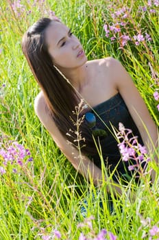 Outdoor shot of beautiful brunette woman with long hair