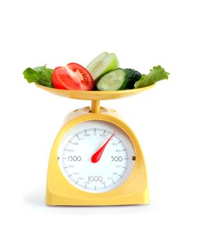 Sliced fruits and vegetables on kitchen scale. Isolated on white with clipping path