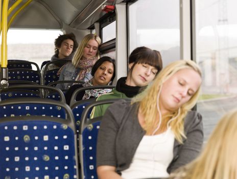 Group of young sleeping people on the bus