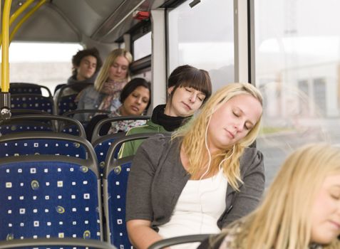 Small group of people sleeping on the bus