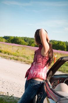 Outdoor shot of beautiful brunette woman with long hair