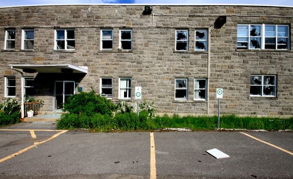 Broken windows by vandalism on historic building