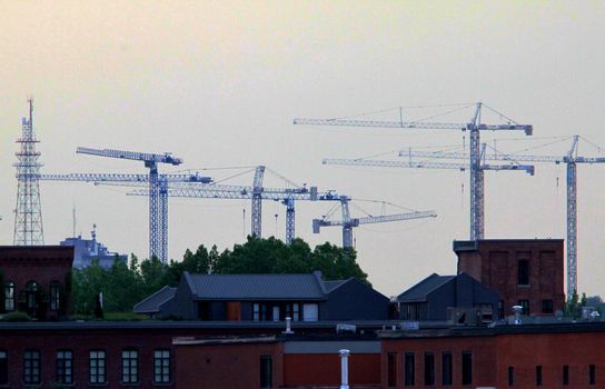 City scape covered with a line of construction cranes