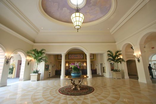 An interior of a hotel lobby with tile floor.