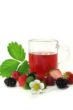 a glass of forest fruit tea with fresh fruit