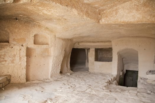 Interior of a cavern in ancient town of Matera - Sassi . It is one of the first human settlements in Italy. The Sassi are houses dug into the calcareous rock itself. Basilicata - Italy.