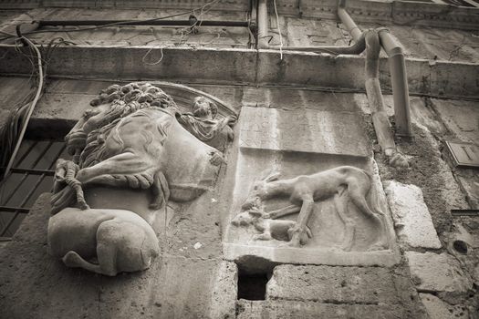 Closeup of old decayed Roman facade. Monochrome image.