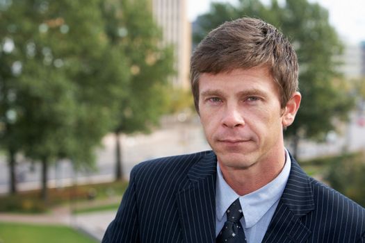 Portrait of man in city park, looking at camera