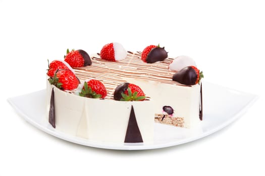 Cheesecake with chocolate and strawberries on the white plate