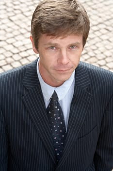 Man standing on street, elevated view, looking at camera