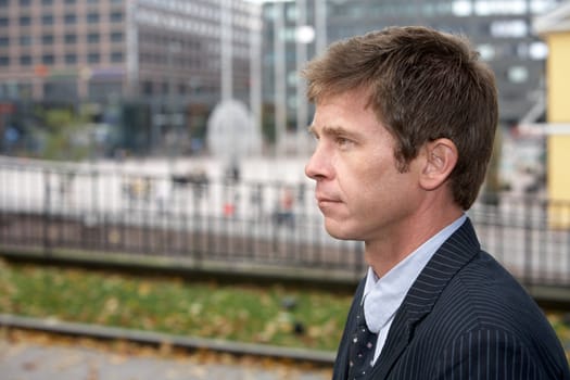 Portrait of man on city street, side profile