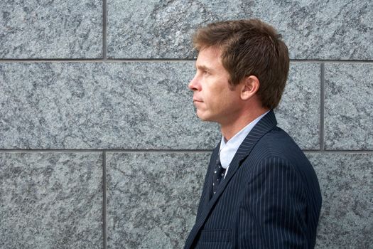 Portrait of man by building wall, side profile