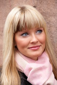 Young woman wearing scarf, smiling, looking away