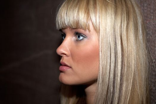 Young woman leaning to wall, close-up 