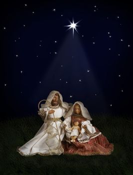 Nativity scene with Jesus, Maria and Joseph  at  globe top on space background under Christmas star beam. World map courtesy of NASA.