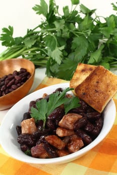 a bowl of kidney beans, parsley and bacon