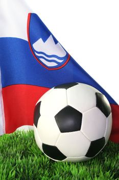 Flag of the Slovenia with football in a field